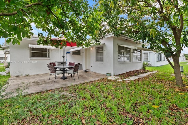 5810 NW 82nd Ter, Tamarac, FL 33321 - back of house with a patio area, stucco siding, and a lawn