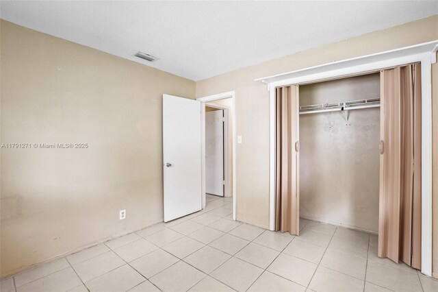 5810 NW 82nd Ter, Tamarac, FL 33321 - unfurnished bedroom with a closet and light tile patterned flooring