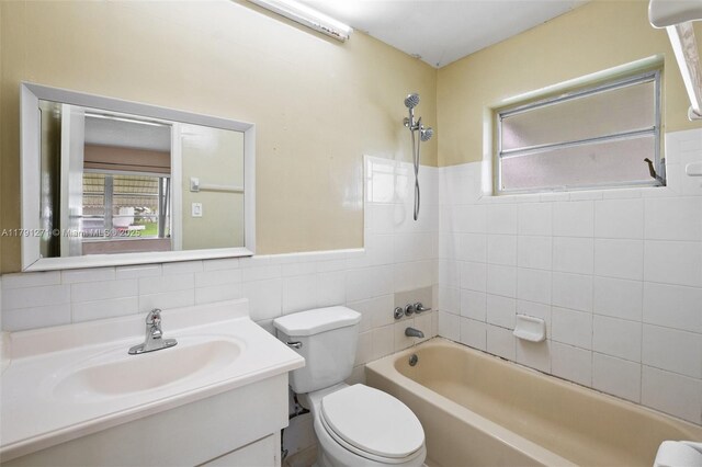 5810 NW 82nd Ter, Tamarac, FL 33321 - full bath with shower / bath combination, toilet, vanity, tile walls, and wainscoting