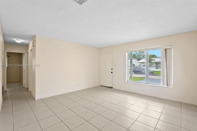 5810 NW 82nd Ter, Tamarac, FL 33321 - spare room with light tile patterned floors and a textured ceiling