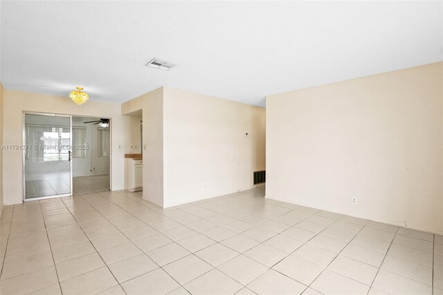 5810 NW 82nd Ter, Tamarac, FL 33321 - spare room featuring light tile patterned flooring, a ceiling fan, and baseboards