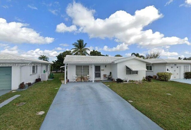 5810 NW 82nd Ter, Tamarac, FL 33321 - ranch-style home with a front yard, concrete driveway, and stucco siding
