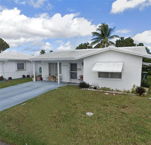 5810 NW 82nd Ter, Tamarac, FL 33321 - ranch-style home with a front lawn, stucco siding, and driveway