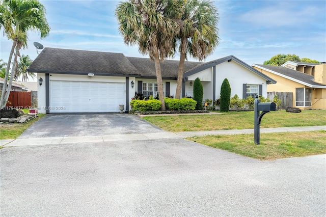 7354 NW 49th Ct, Lauderhill, FL 33319 - ranch-style house featuring a front lawn, fence, stucco siding, an attached garage, and driveway