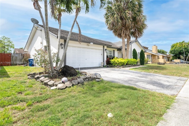 7354 NW 49th Ct, Lauderhill, FL 33319 - ranch-style house with a garage, fence, a front yard, stucco siding, and driveway