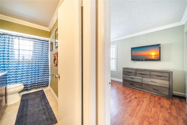 7354 NW 49th Ct, Lauderhill, FL 33319 - bathroom with crown molding, baseboards, toilet, and wood finished floors