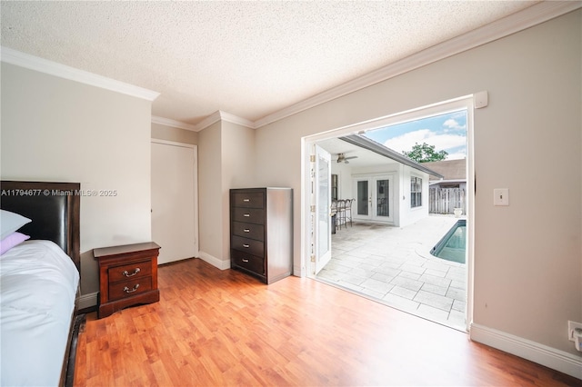 7354 NW 49th Ct, Lauderhill, FL 33319 - unfurnished bedroom with a textured ceiling, access to exterior, baseboards, wood finished floors, and ornamental molding