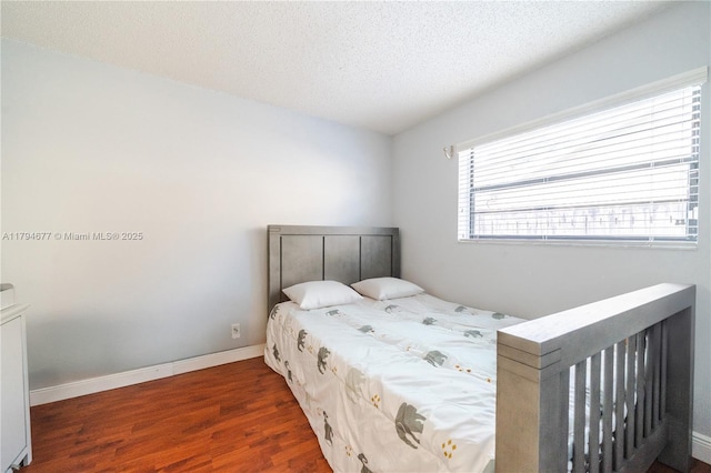 7354 NW 49th Ct, Lauderhill, FL 33319 - bedroom featuring a textured ceiling, baseboards, and wood finished floors