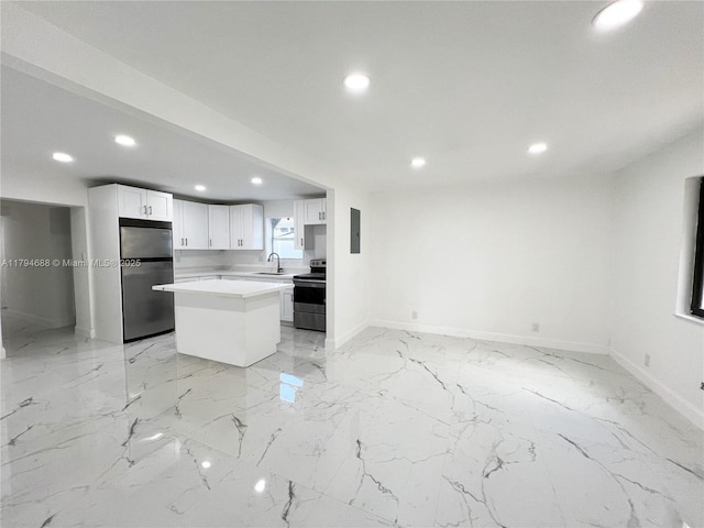 kitchen featuring light countertops, appliances with stainless steel finishes, baseboards, and recessed lighting