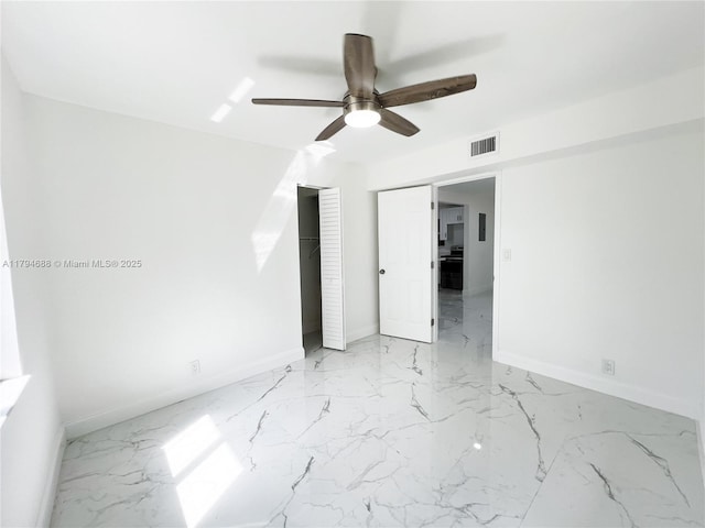 unfurnished bedroom featuring visible vents, a ceiling fan, marble finish floor, and baseboards