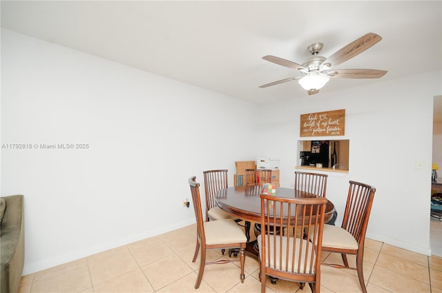 dining area with baseboards, a ceiling fan, and light tile patterned flooring