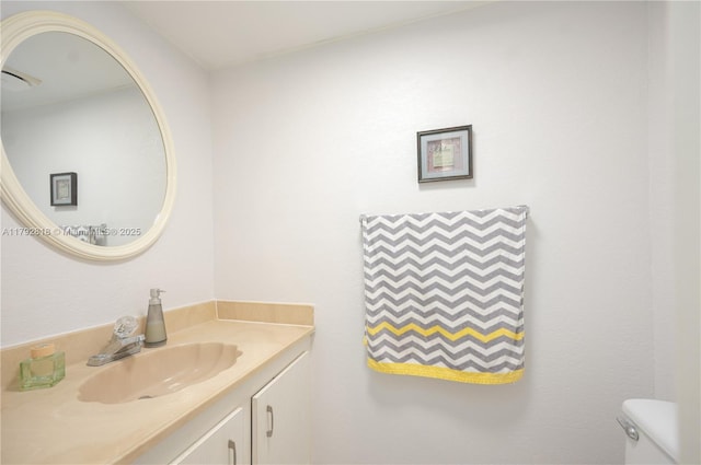 bathroom with toilet and vanity