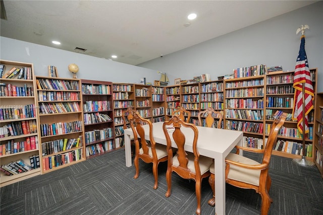 living area with recessed lighting, carpet flooring, and bookshelves