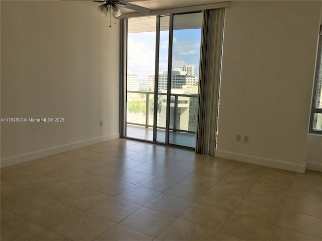 1050 Brickell Ave Unit 1602, Miami, FL 33131 - tiled empty room with baseboards, floor to ceiling windows, a ceiling fan, and a view of city