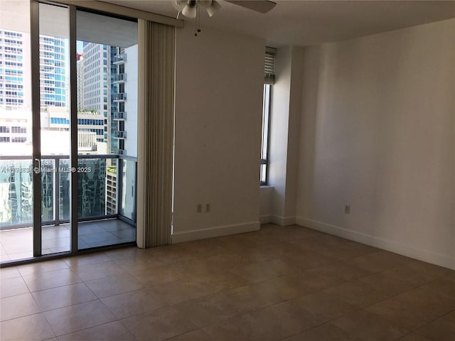 1050 Brickell Ave Unit 1602, Miami, FL 33131 - empty room featuring expansive windows, tile patterned flooring, and a healthy amount of sunlight