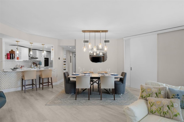 701 Brickell Key Blvd Unit 1812, Miami, FL 33131 - dining room with visible vents, wood finished floors, and an inviting chandelier