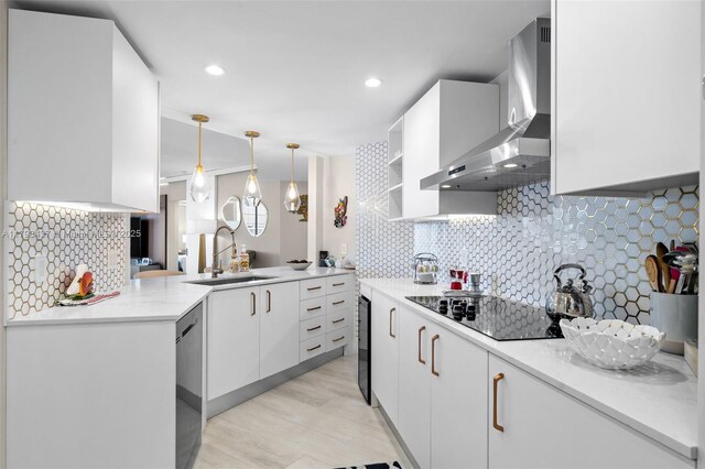 701 Brickell Key Blvd Unit 1812, Miami, FL 33131 - kitchen featuring a sink, wall chimney range hood, tasteful backsplash, black electric stovetop, and white cabinets