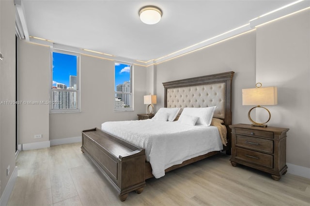 701 Brickell Key Blvd Unit 1812, Miami, FL 33131 - bedroom with light wood-type flooring, a view of city, and baseboards