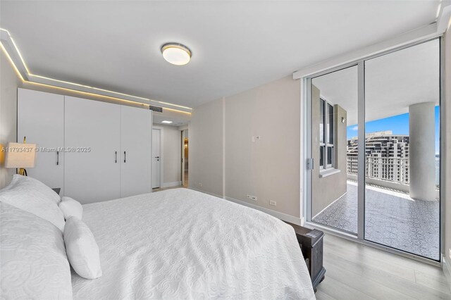 701 Brickell Key Blvd Unit 1812, Miami, FL 33131 - bedroom with baseboards, access to exterior, visible vents, and wood finished floors