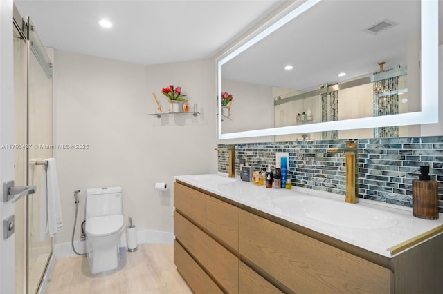 701 Brickell Key Blvd Unit 1812, Miami, FL 33131 - bathroom with toilet, visible vents, baseboards, a shower stall, and backsplash