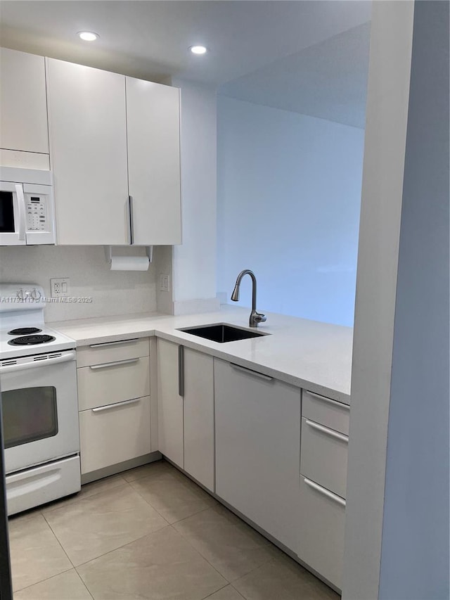 400 N Riverside Dr Unit 512, Pompano Beach, FL 33062 - kitchen featuring white appliances, a sink, light countertops, white cabinetry, and recessed lighting