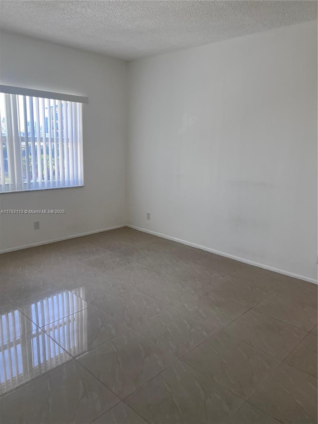 400 N Riverside Dr Unit 512, Pompano Beach, FL 33062 - spare room featuring a textured ceiling and tile patterned floors