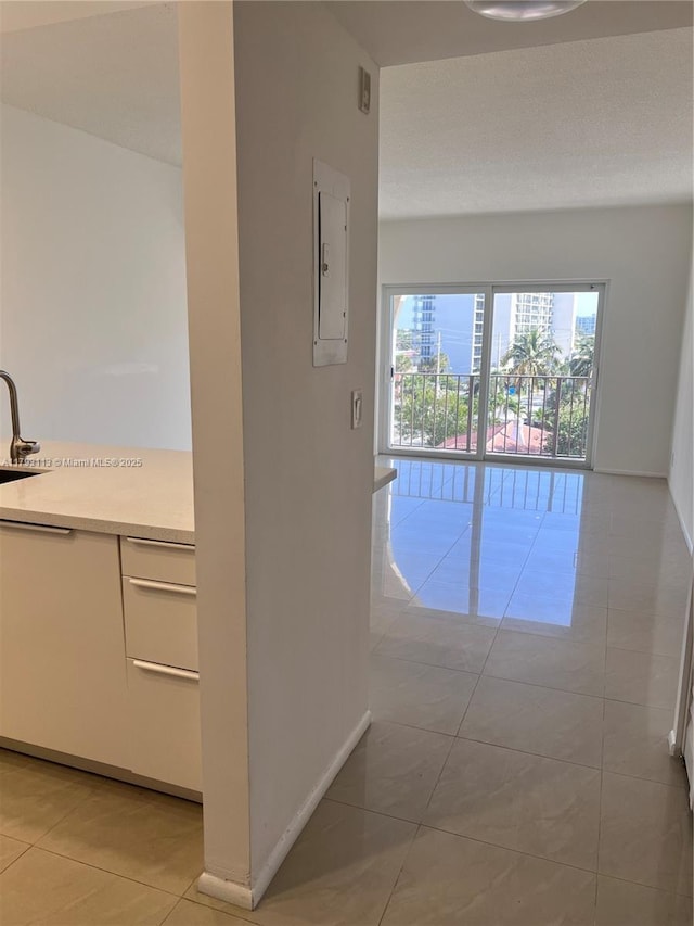 400 N Riverside Dr Unit 512, Pompano Beach, FL 33062 - corridor with electric panel, light tile patterned flooring, a sink, and baseboards