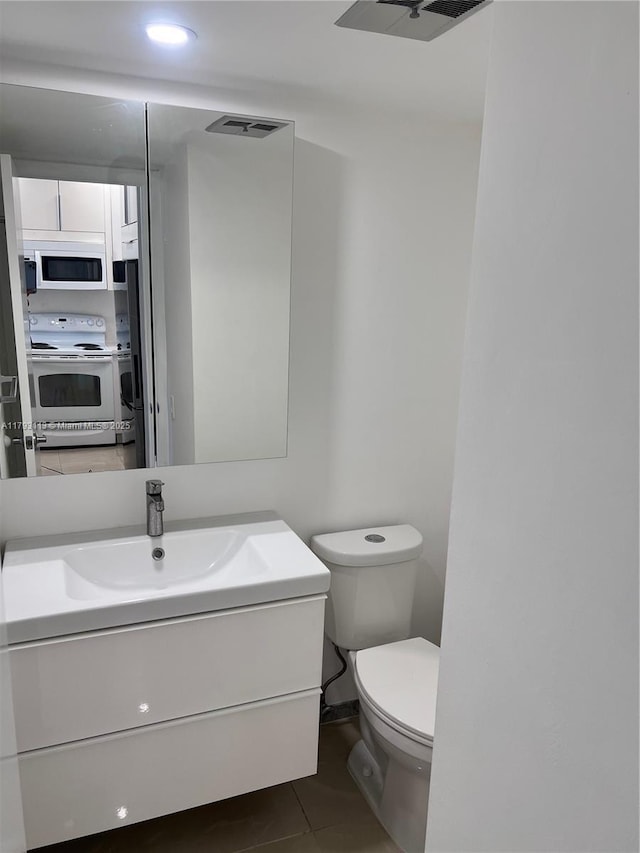 400 N Riverside Dr Unit 512, Pompano Beach, FL 33062 - bathroom featuring vanity, toilet, tile patterned flooring, and recessed lighting