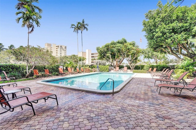 community pool featuring a patio and fence
