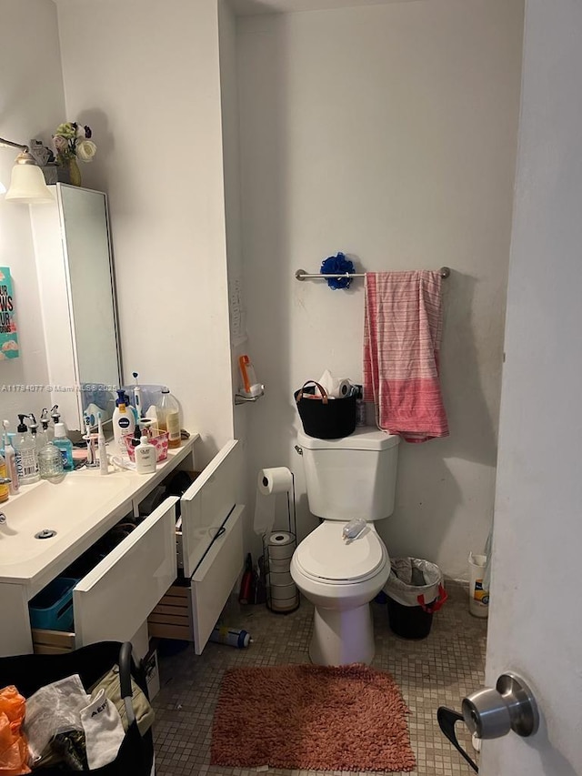 bathroom with vanity, tile patterned flooring, and toilet