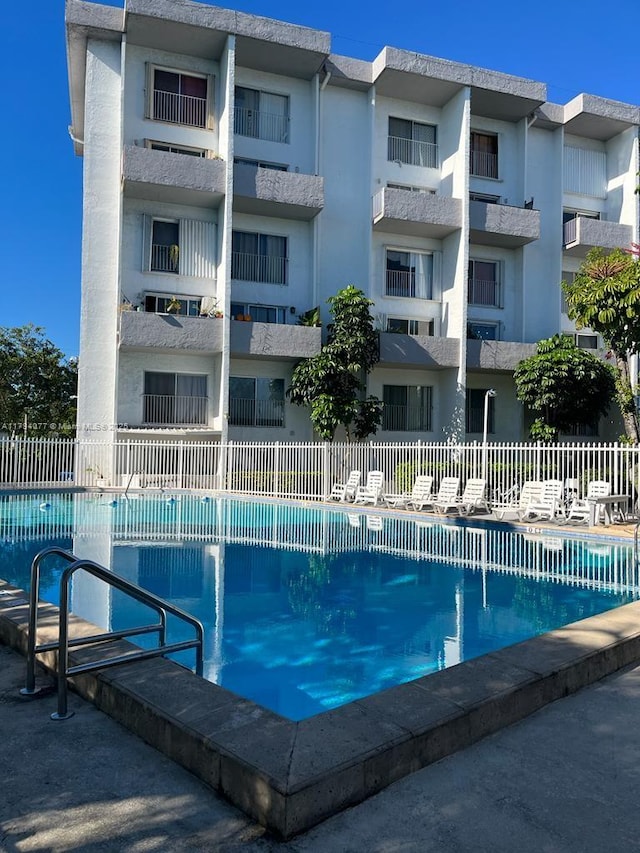 community pool featuring fence