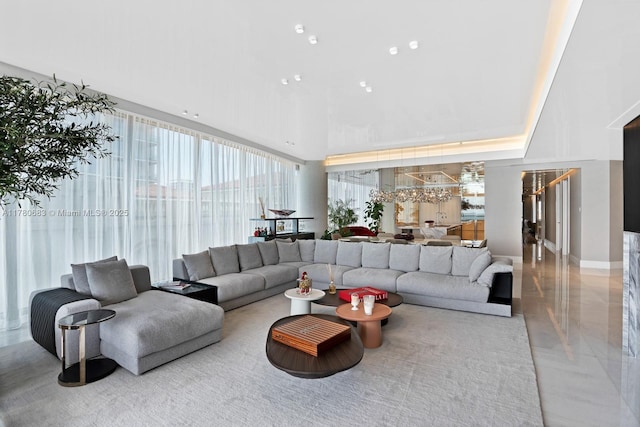living room with a high ceiling and baseboards