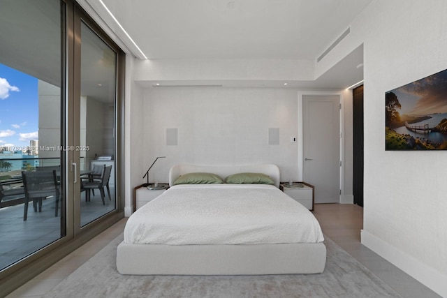 bedroom with baseboards and access to exterior