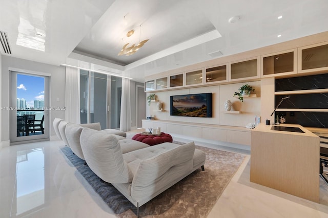 living room featuring a raised ceiling