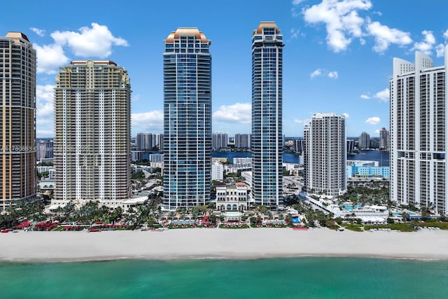 property's view of city with a water view and a beach view