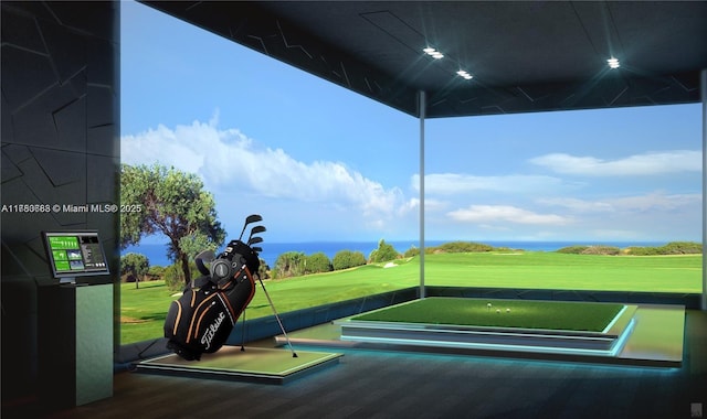 view of property's community with golf simulator, a yard, and golf course view