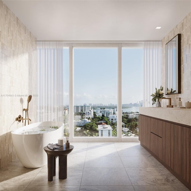full bath featuring vanity, a view of city, tile walls, tile patterned floors, and a soaking tub