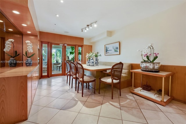 dining area featuring recessed lighting, light tile patterned floors, and wooden walls