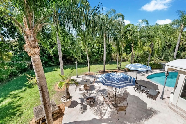 pool with a patio and a yard
