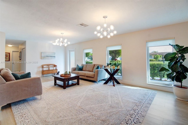 10861 SW 126th St, Miami, FL 33176 - living room with an inviting chandelier, a healthy amount of sunlight, light wood-style flooring, and visible vents
