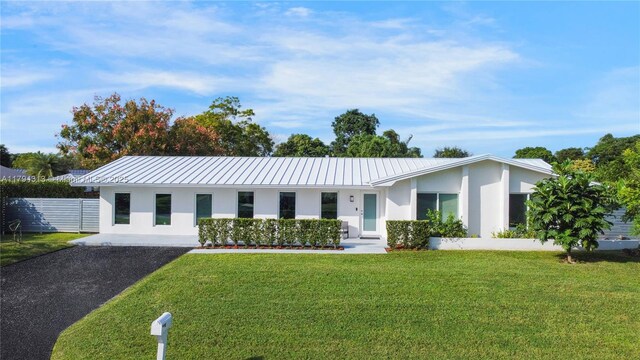 10861 SW 126th St, Miami, FL 33176 - single story home with a standing seam roof, stucco siding, a front lawn, and metal roof