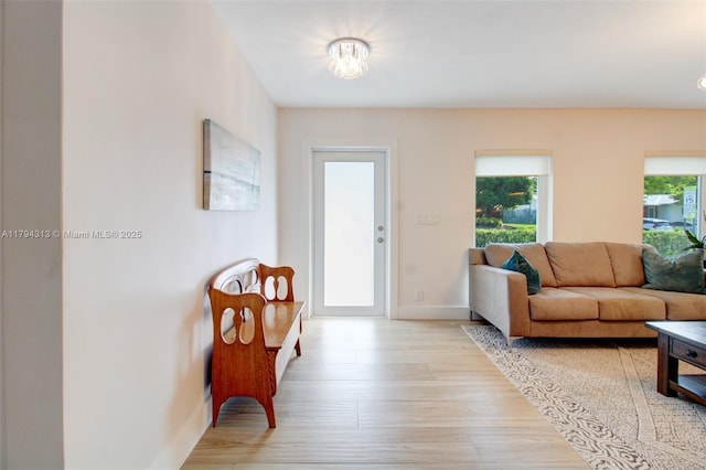 10861 SW 126th St, Miami, FL 33176 - living room with baseboards, a notable chandelier, and light wood-style flooring