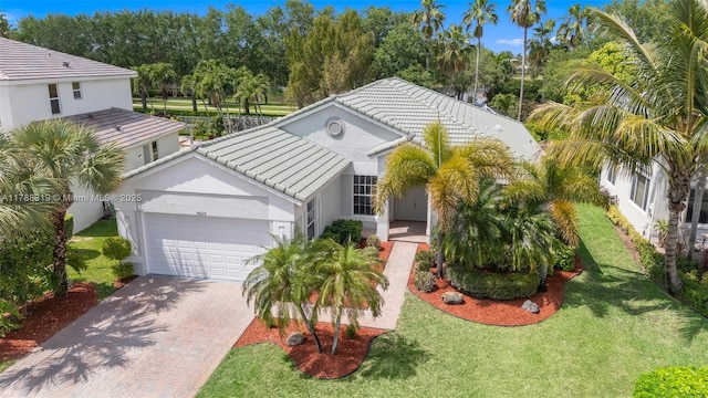 4629 Mariners Cove Dr, Wellington, FL 33449 - view of front of property featuring an attached garage, decorative driveway, a tile roof, stucco siding, and a front yard