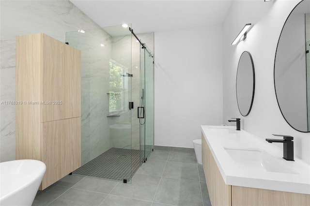 4629 Mariners Cove Dr, Wellington, FL 33449 - full bath featuring a marble finish shower, double vanity, a freestanding tub, and tile patterned flooring