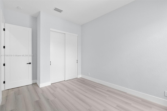 4629 Mariners Cove Dr, Wellington, FL 33449 - unfurnished bedroom featuring light wood-style flooring and a closet
