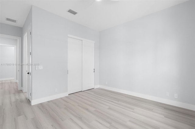 4629 Mariners Cove Dr, Wellington, FL 33449 - unfurnished bedroom featuring light wood finished floors and a closet