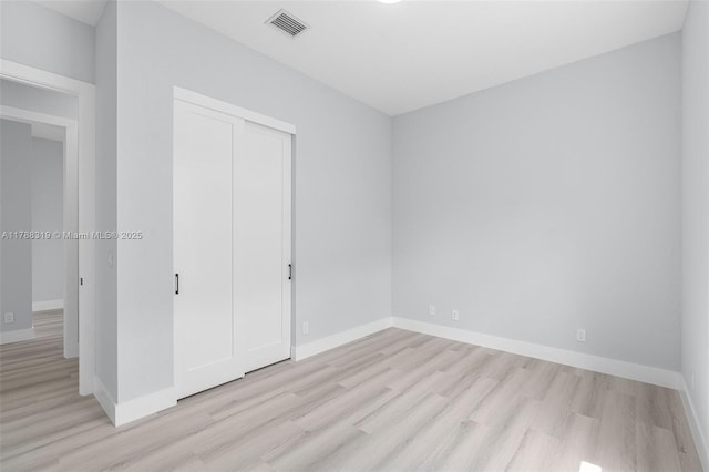 4629 Mariners Cove Dr, Wellington, FL 33449 - unfurnished bedroom featuring light wood-type flooring and a closet