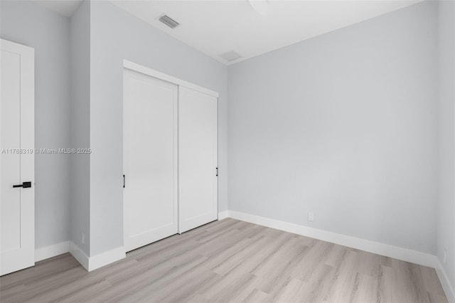 4629 Mariners Cove Dr, Wellington, FL 33449 - unfurnished bedroom featuring light wood finished floors and a closet