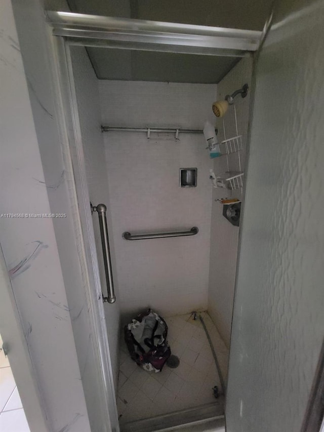bathroom featuring tile patterned floors and a stall shower