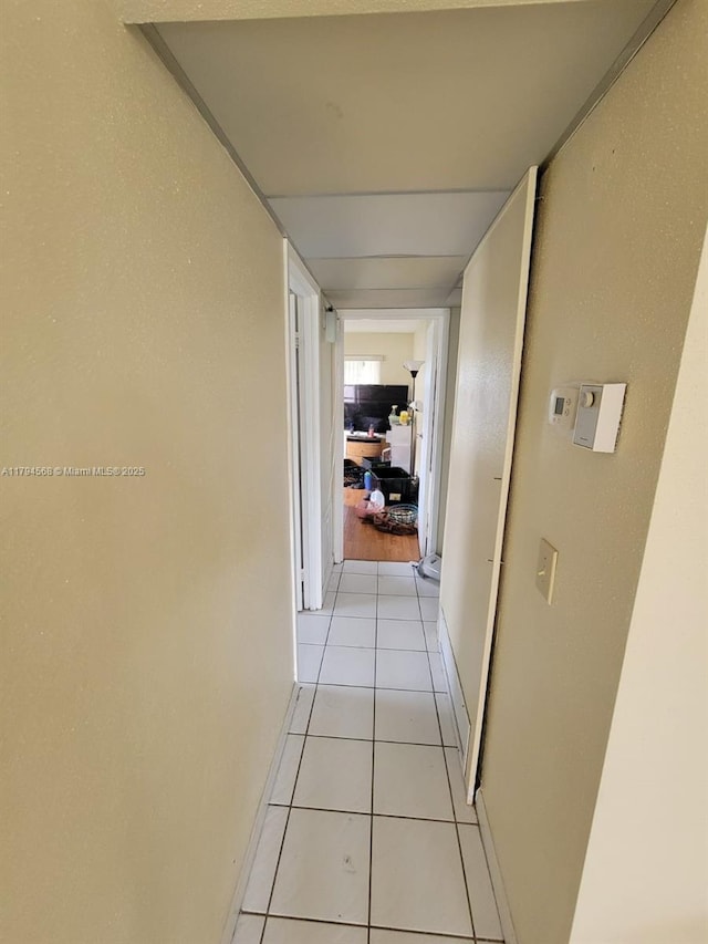 corridor with light tile patterned floors